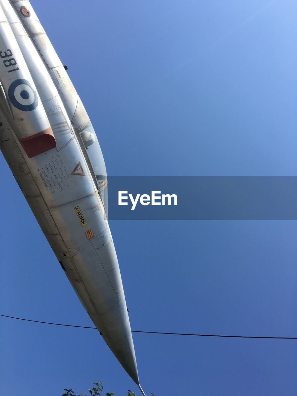 LOW ANGLE VIEW OF AIRPLANE FLYING IN SKY