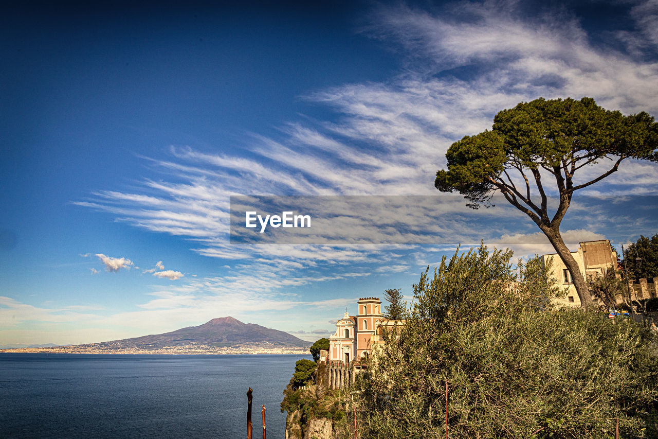 Vico equense's cathedral and the vesuvius in the background. italy