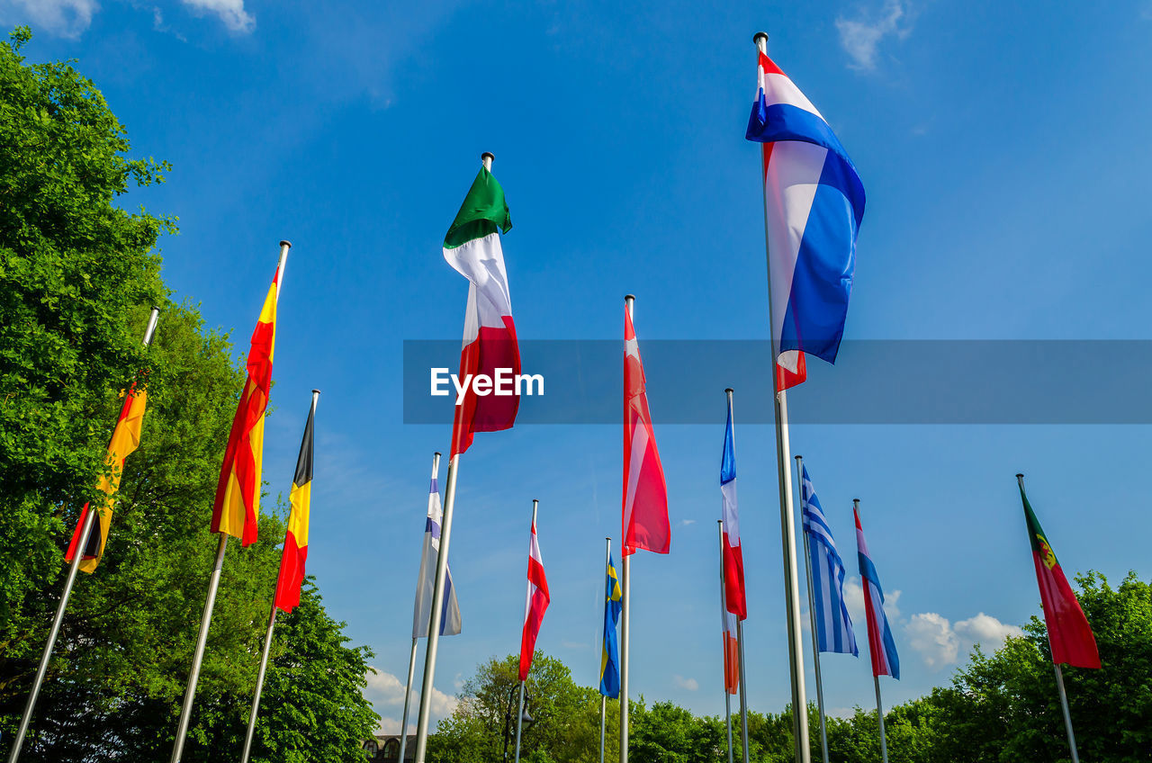 Low angle view of flags against sky