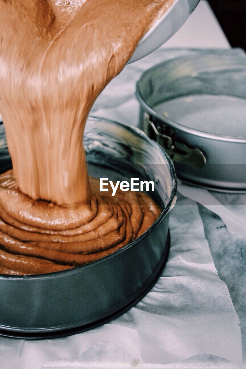 Close-up of batter pouring in container