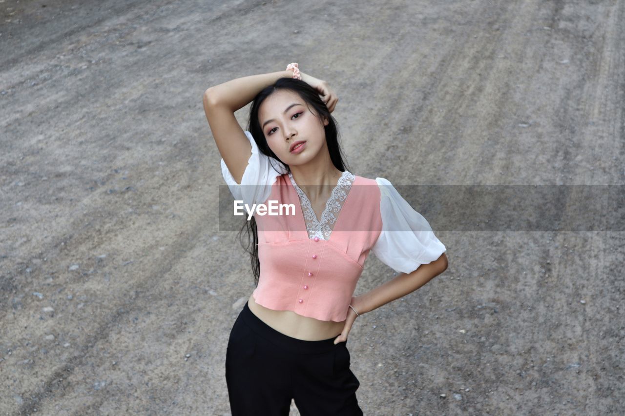 Full length of a young woman standing outdoors