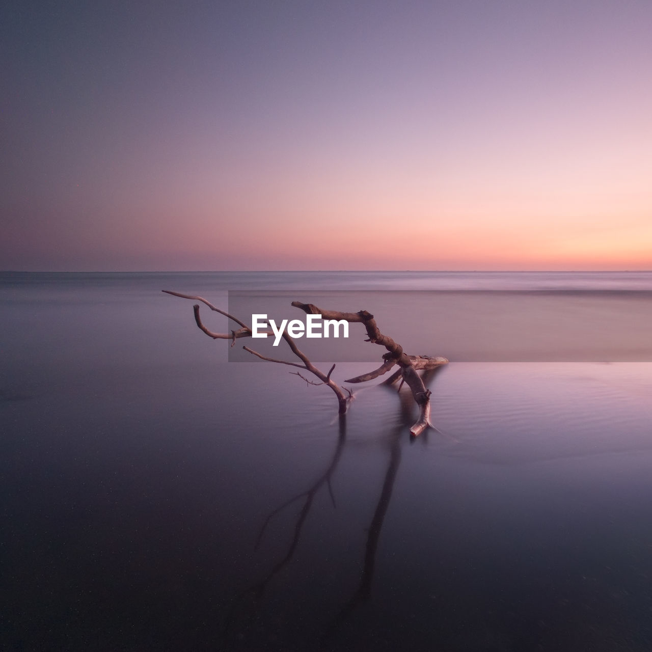 Scenic view of sea against clear sky at sunset