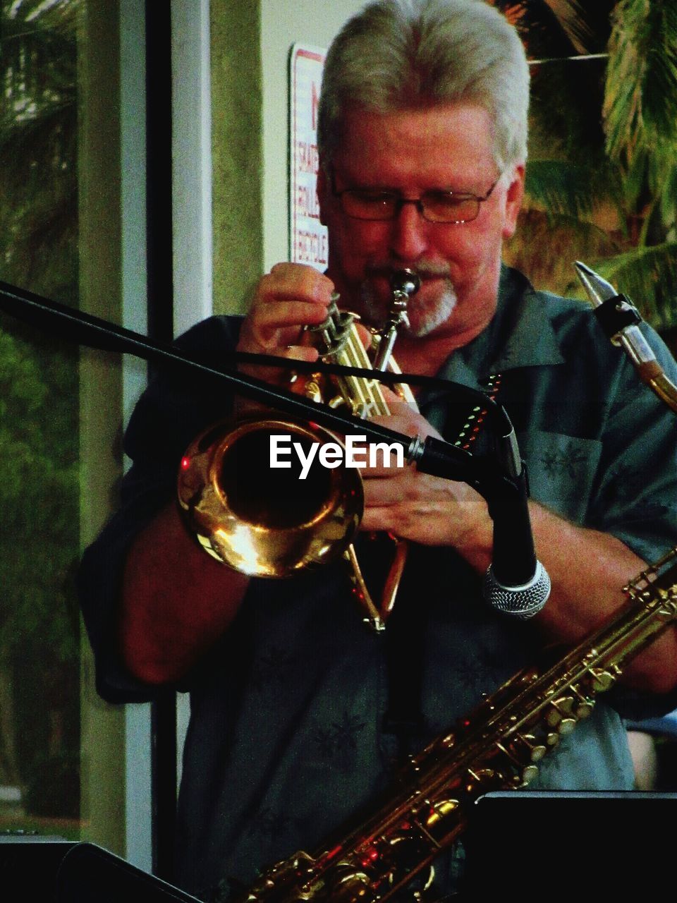 Musician playing trumpet in cafe