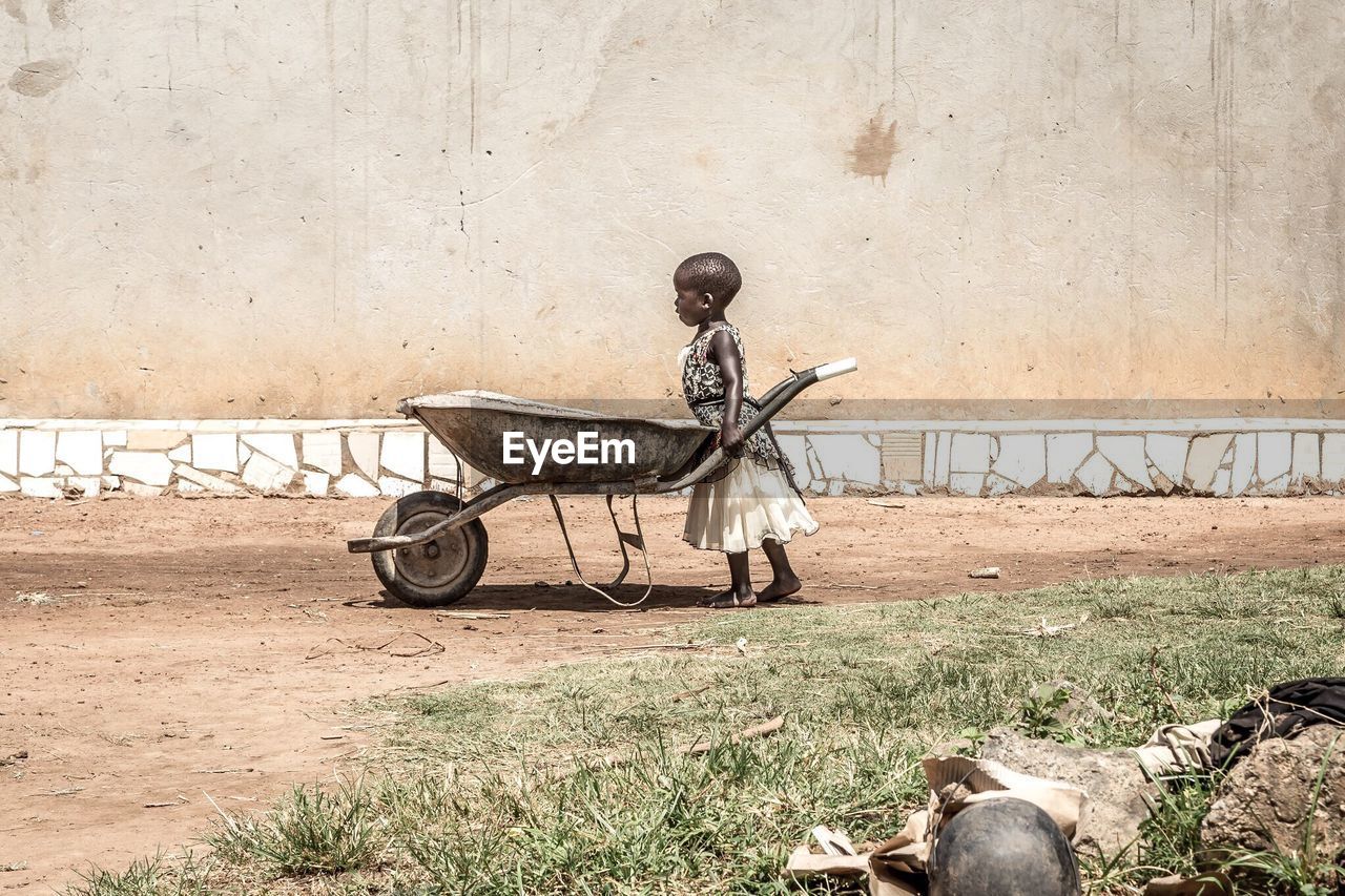 MAN SITTING ON CART