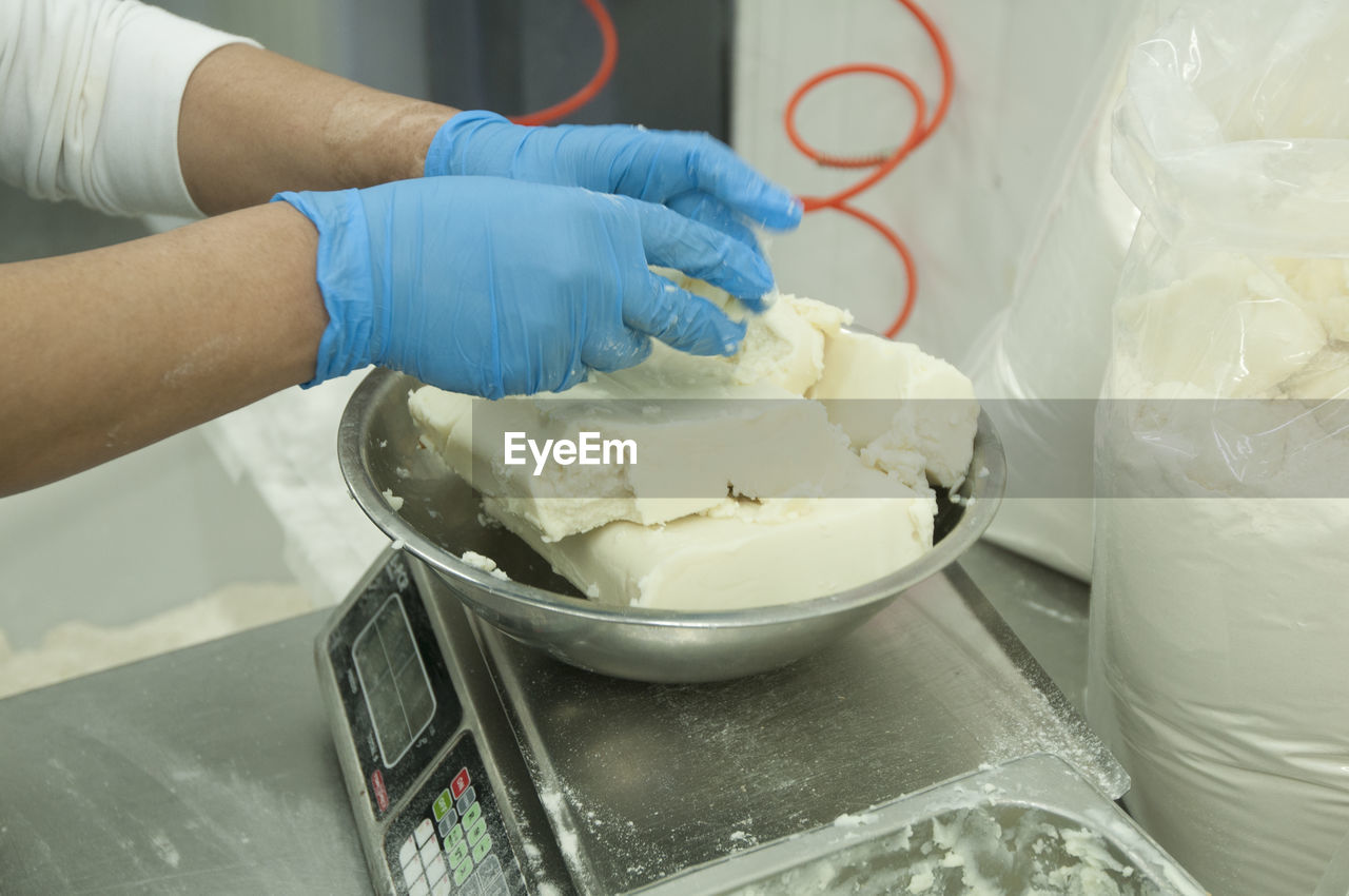 Cropped hands of chef measuring food in commercial kitchen