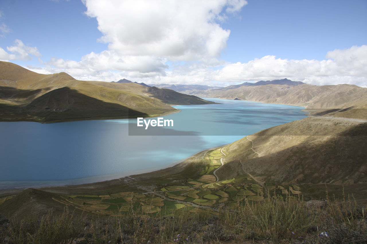 Scenic view of lake and mountains against sky