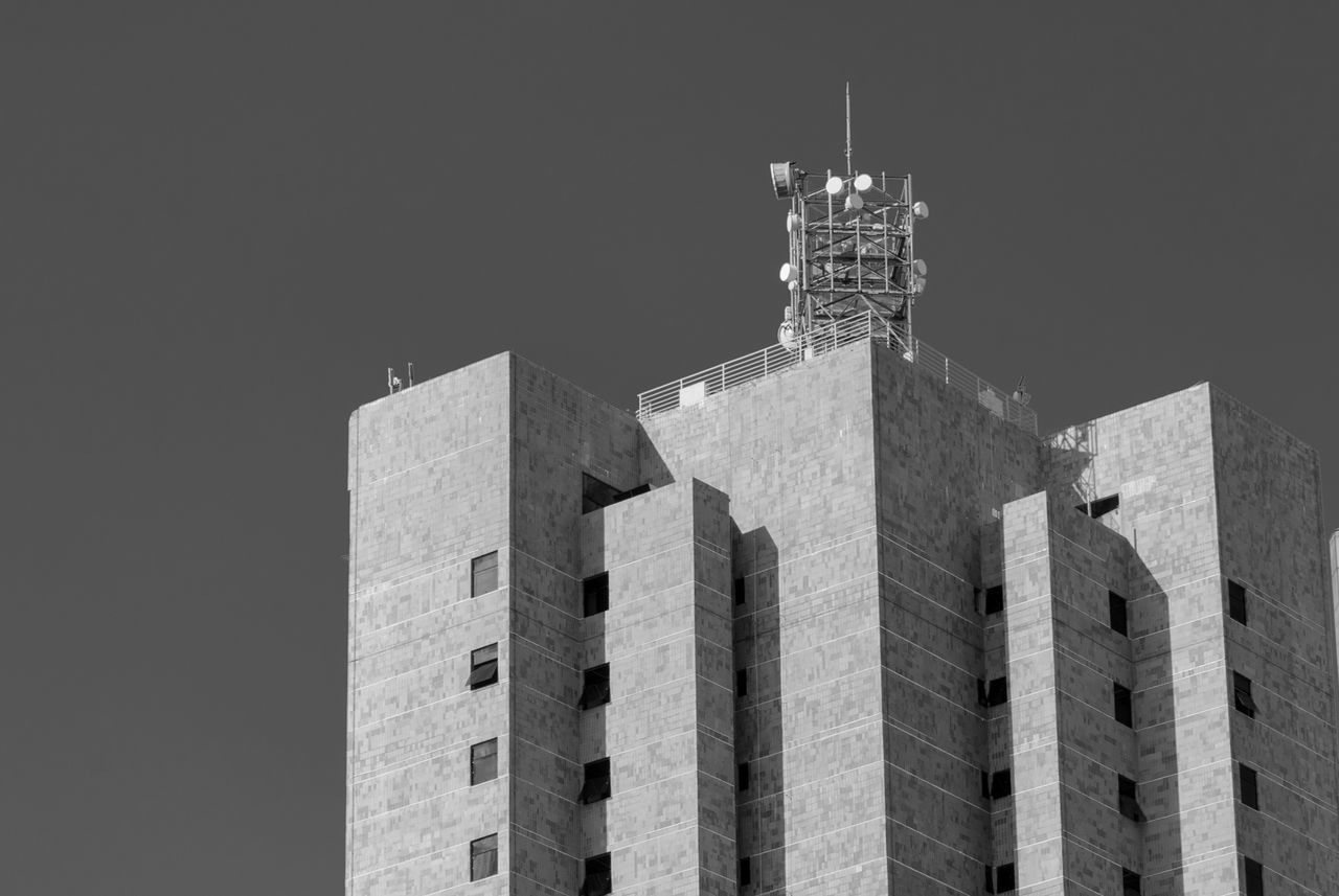 Low angle view of building against sky on sunny day