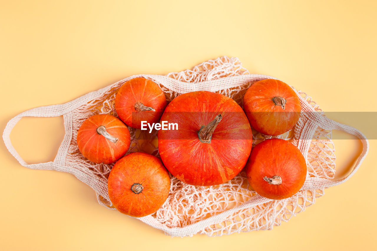 directly above shot of fruits in plate on yellow background