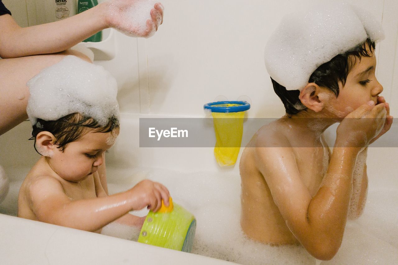 Two young children taking a bath at home