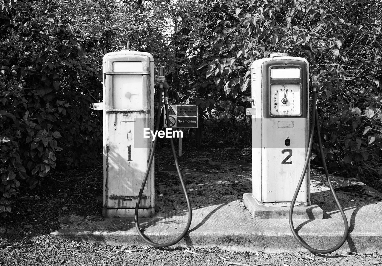 Abandoned gas station against tree