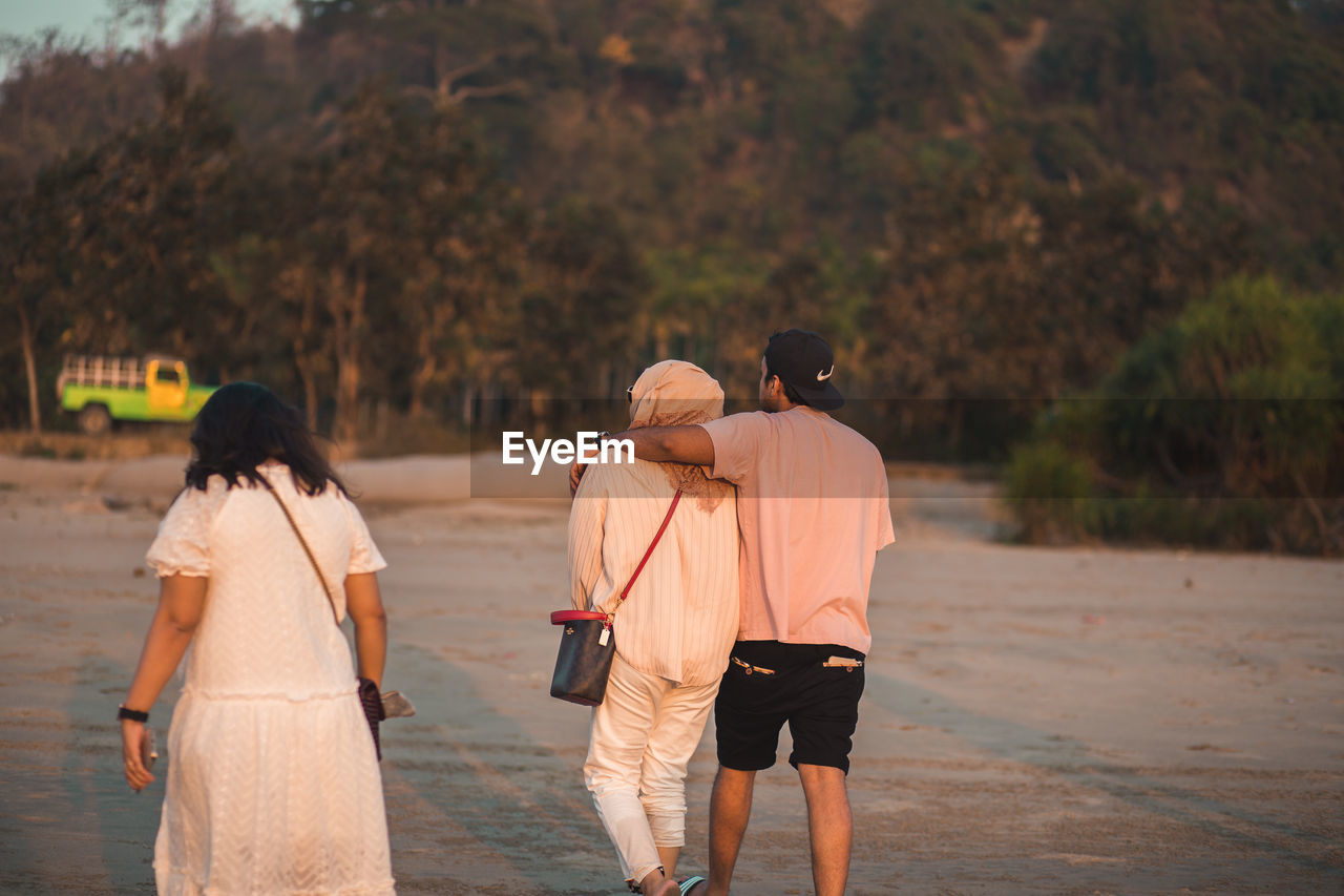 adult, rear view, two people, walking, women, togetherness, men, nature, ceremony, beach, water, clothing, land, emotion, travel, love, outdoors, lifestyles, positive emotion, female, full length, friendship, person, holding hands, tourism, vacation