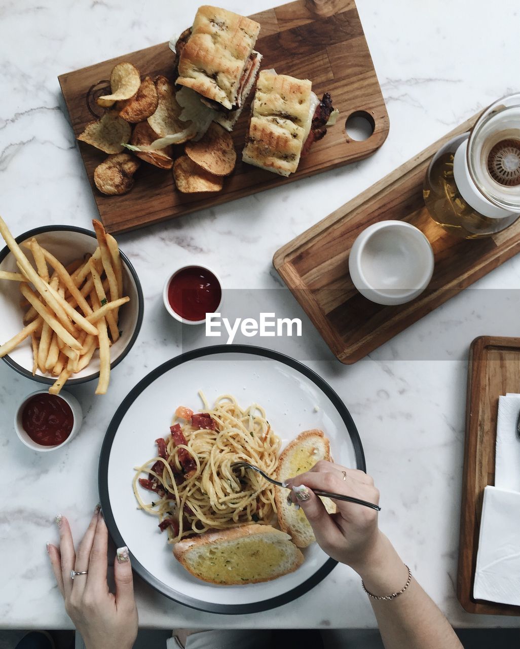 Close-up of hands eating food at table