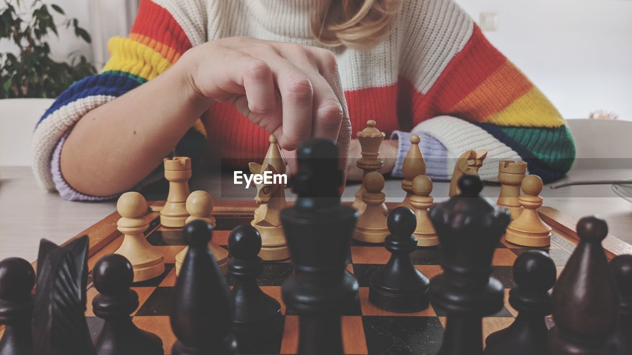 Midsection of woman playing chess