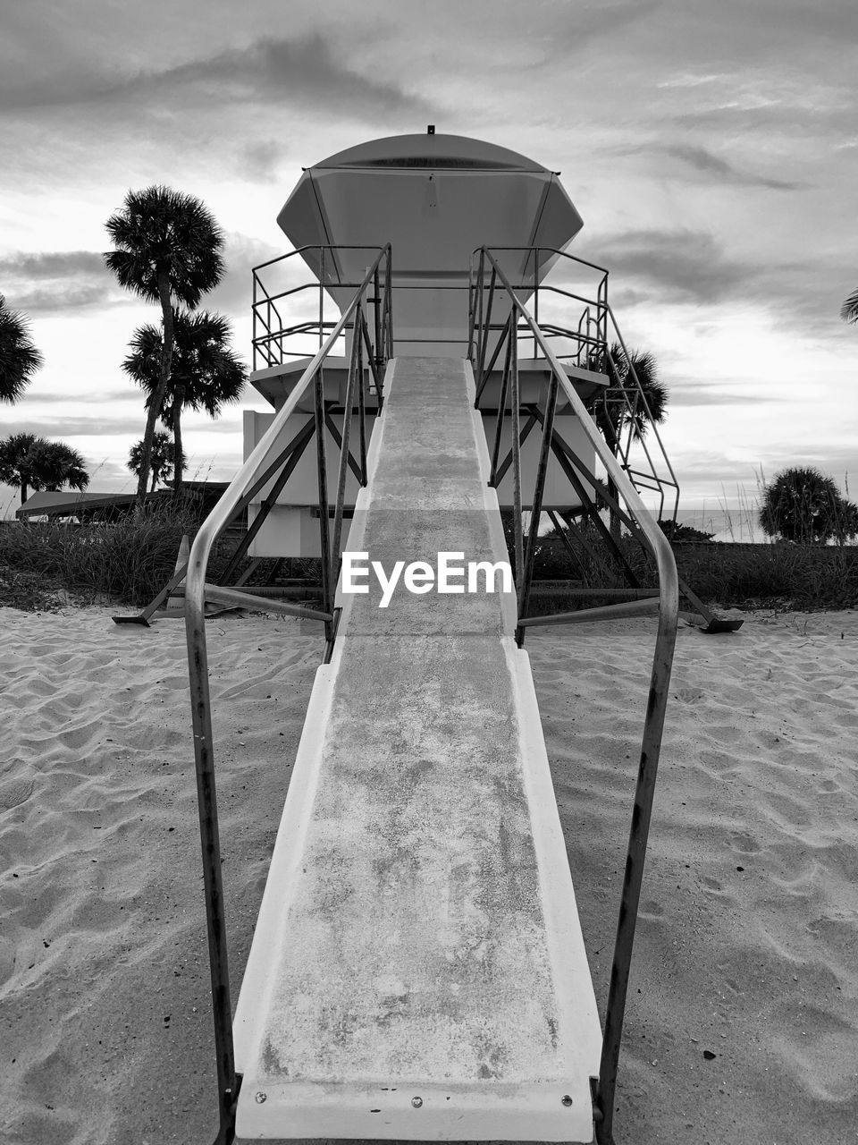 black and white, sky, white, monochrome, monochrome photography, beach, nature, cloud, black, sand, land, water, tree, architecture, built structure, sea, playground, no people, outdoors, plant, day, palm tree, slide, tropical climate
