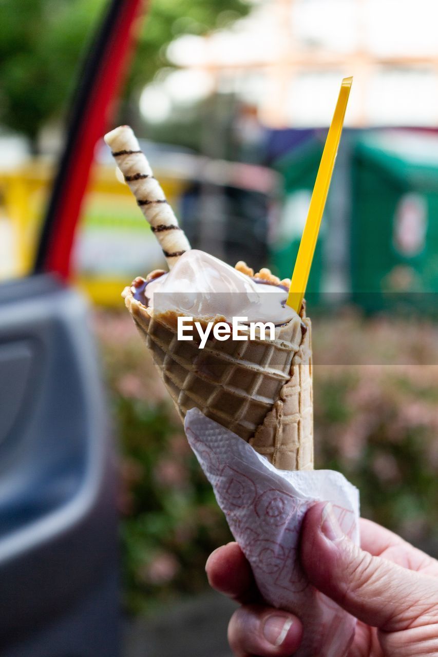 Close-up of hand holding ice cream