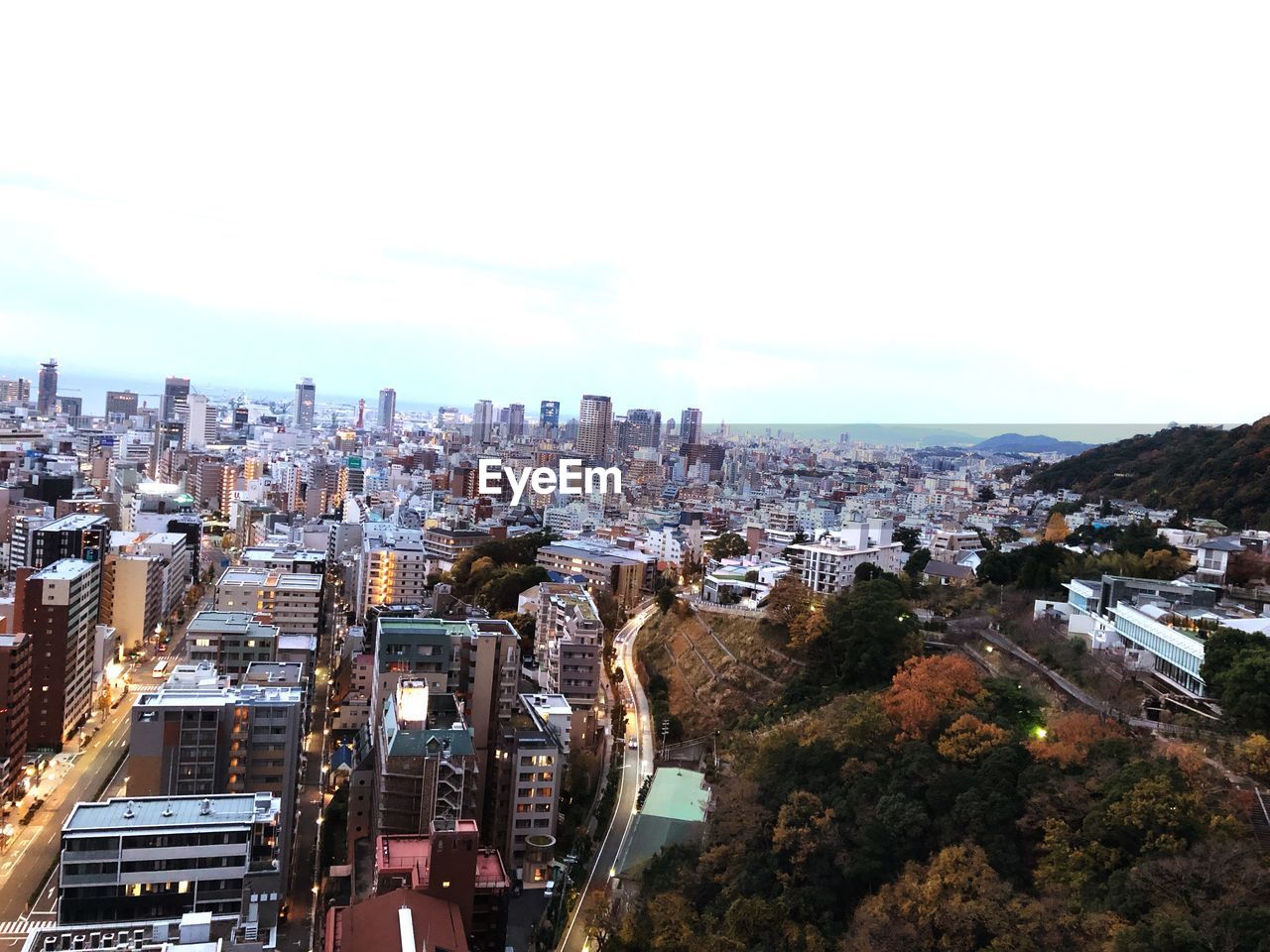 HIGH ANGLE VIEW OF MODERN BUILDINGS IN CITY AGAINST SKY