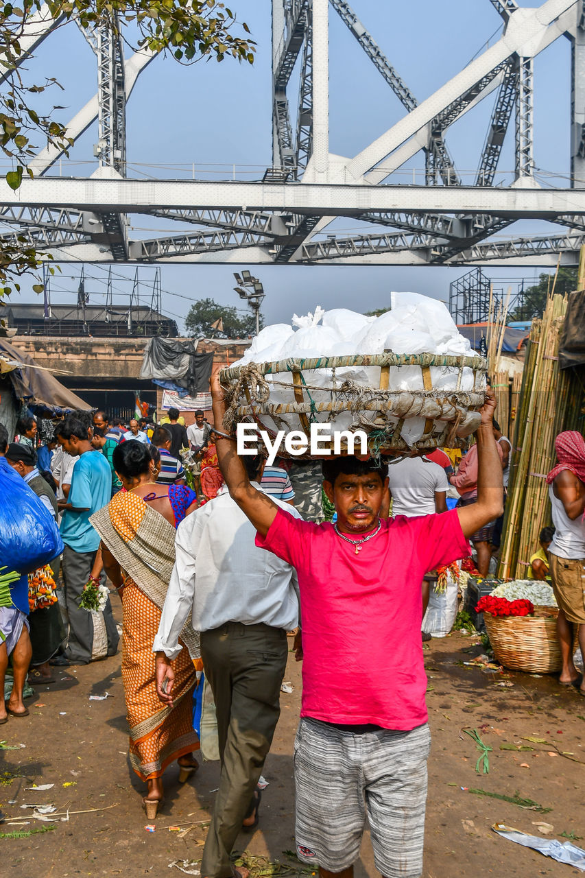 PEOPLE STANDING IN MARKET