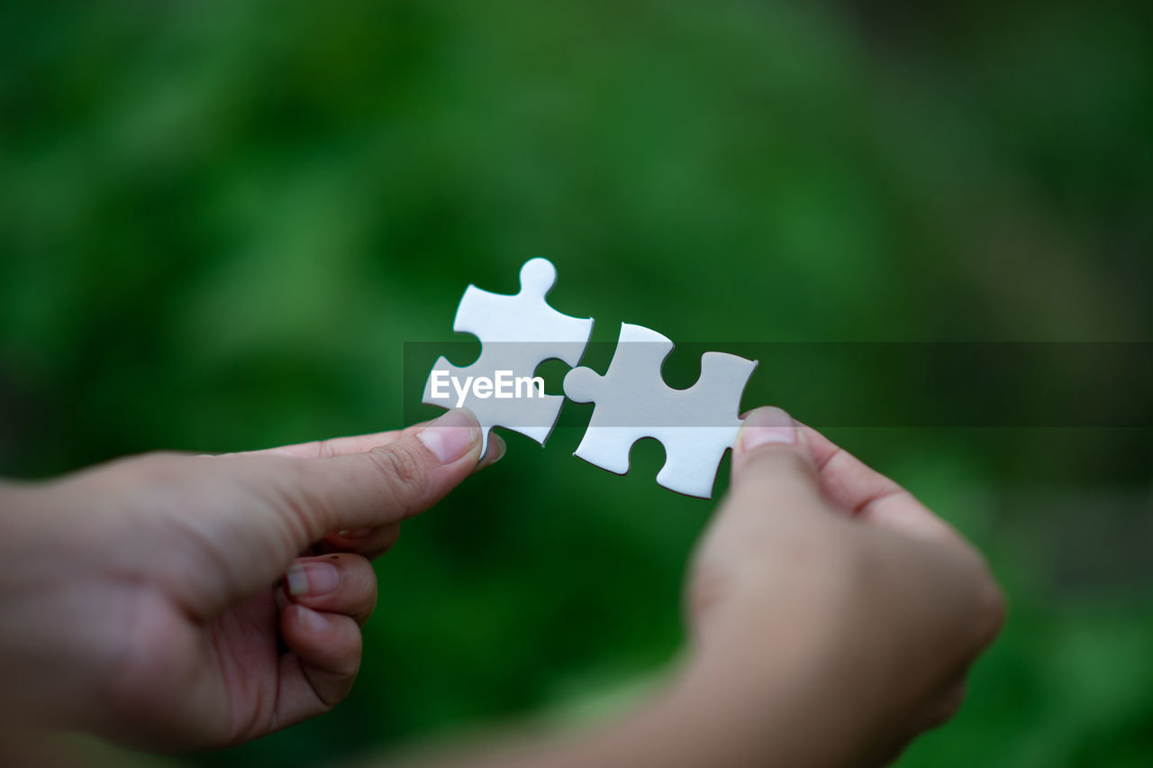 Cropped woman holding jigsaw pieces