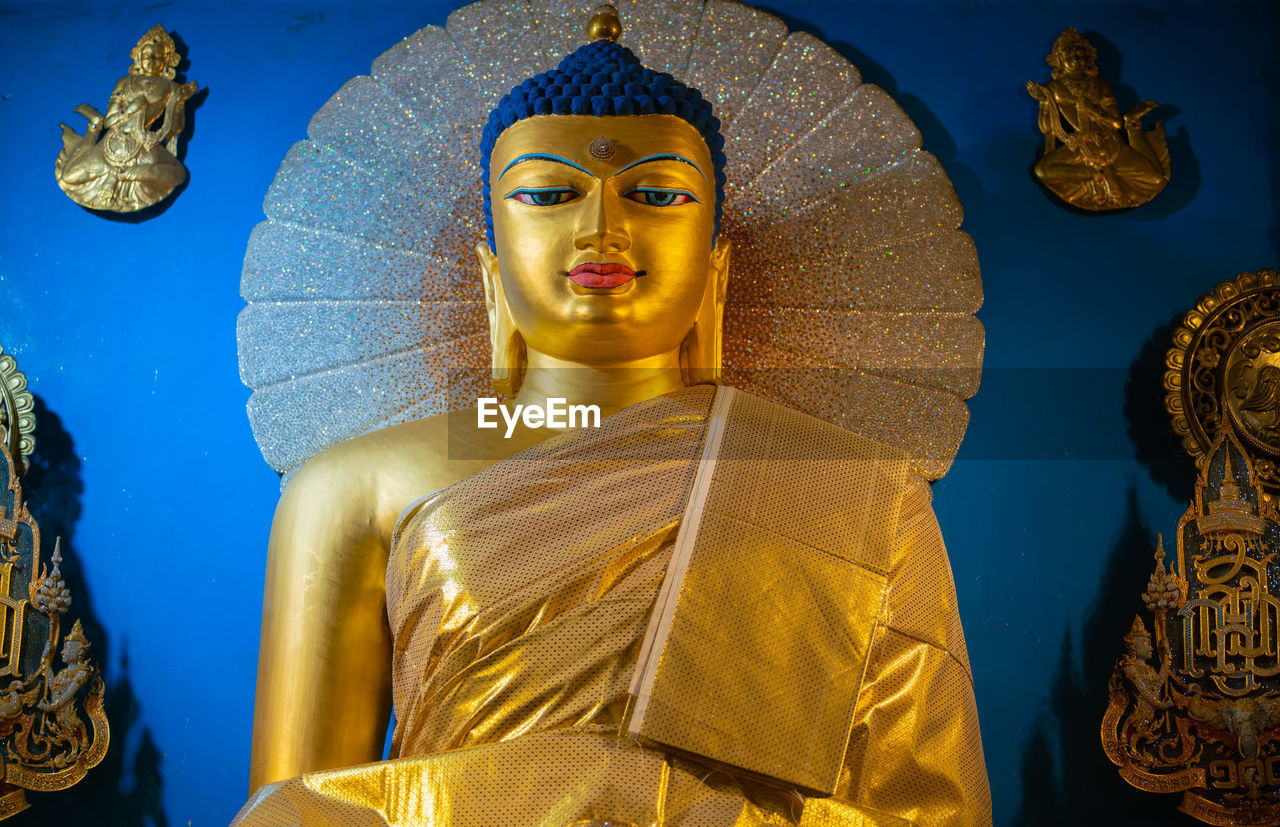 Statue of buddha against temple