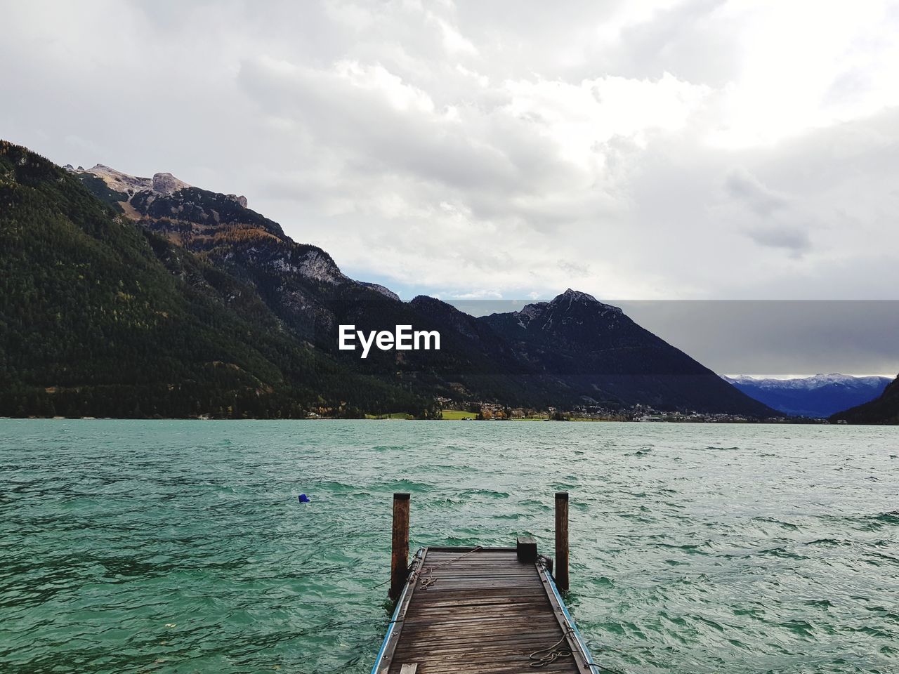 PIER AMIDST LAKE AGAINST SKY