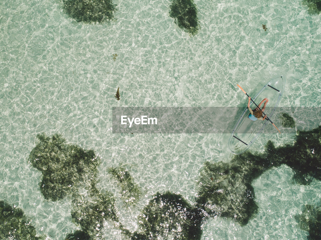 Aerial view of woman kayaking in sea