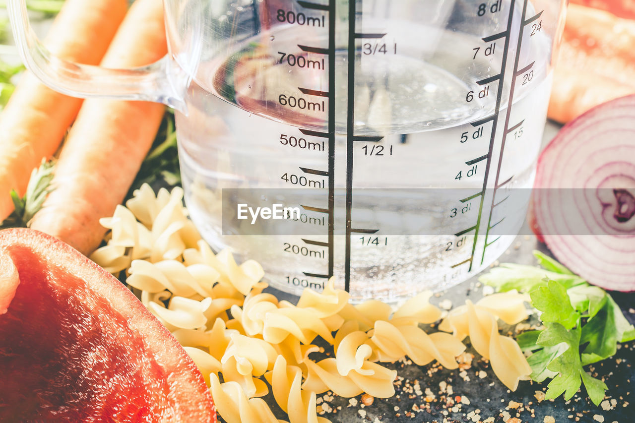 CLOSE-UP OF FRUITS IN GLASS JAR ON TABLE