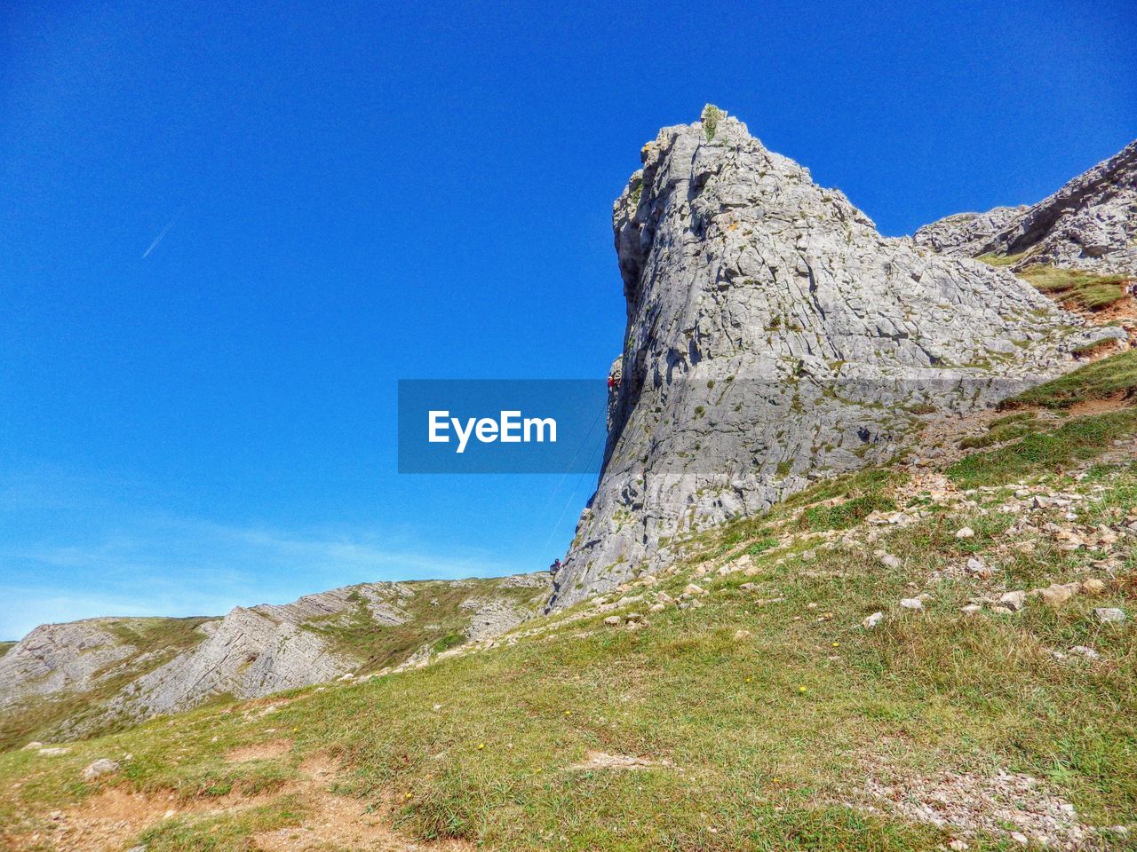 Low angle view of mountains against clear blue sky