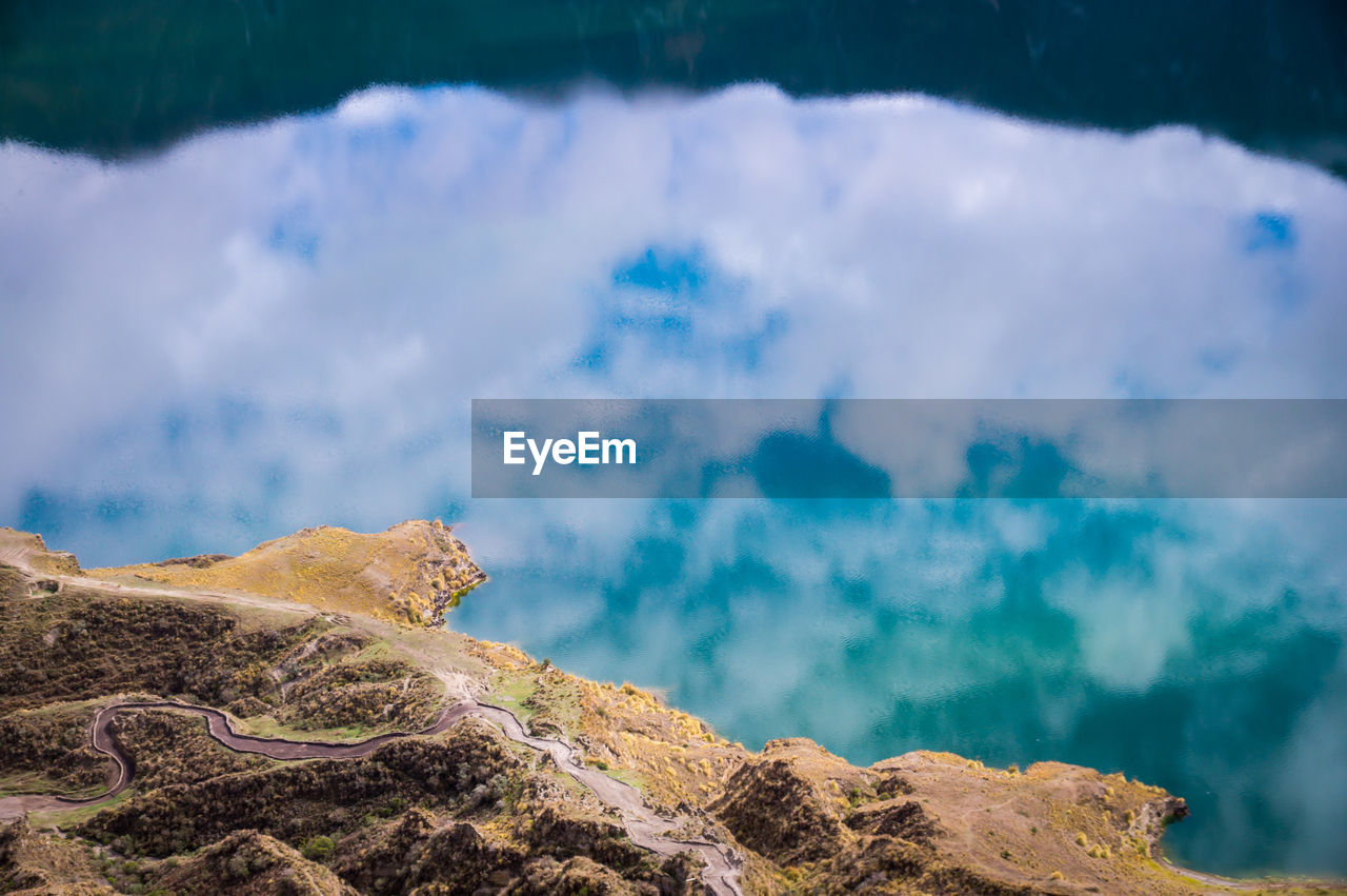 SCENIC VIEW OF SEA AND MOUNTAIN AGAINST SKY