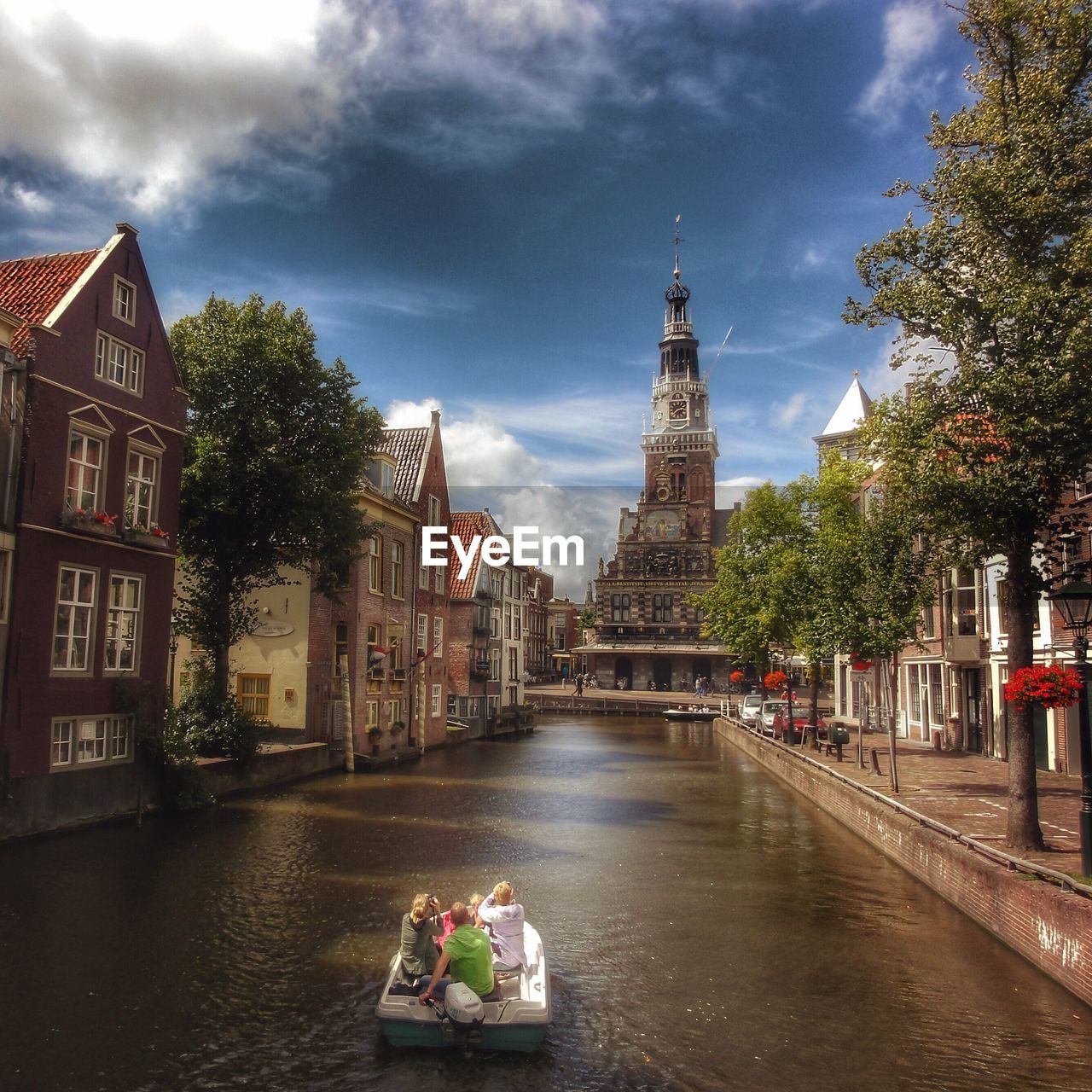 High angle view of people on motorboat sailing in canal