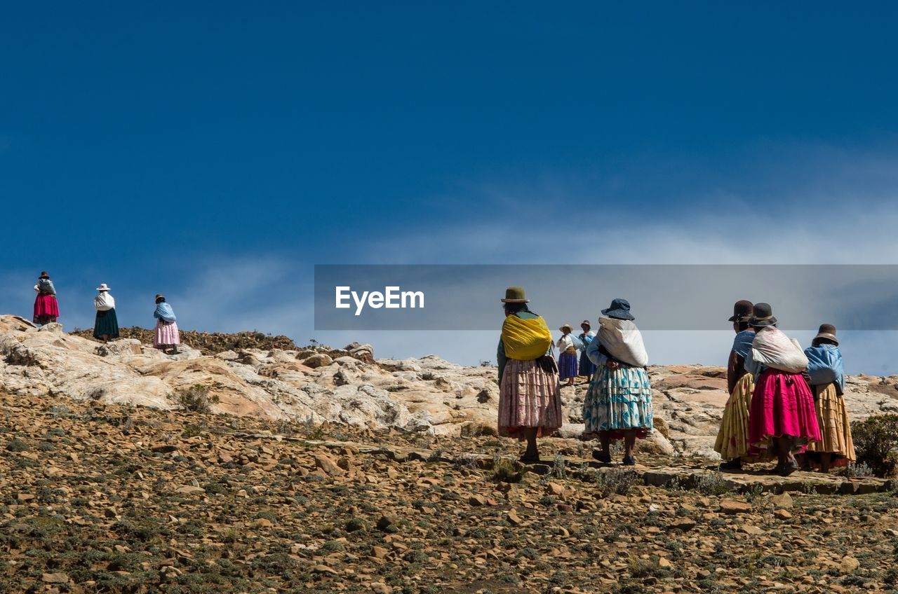 People on land against sky