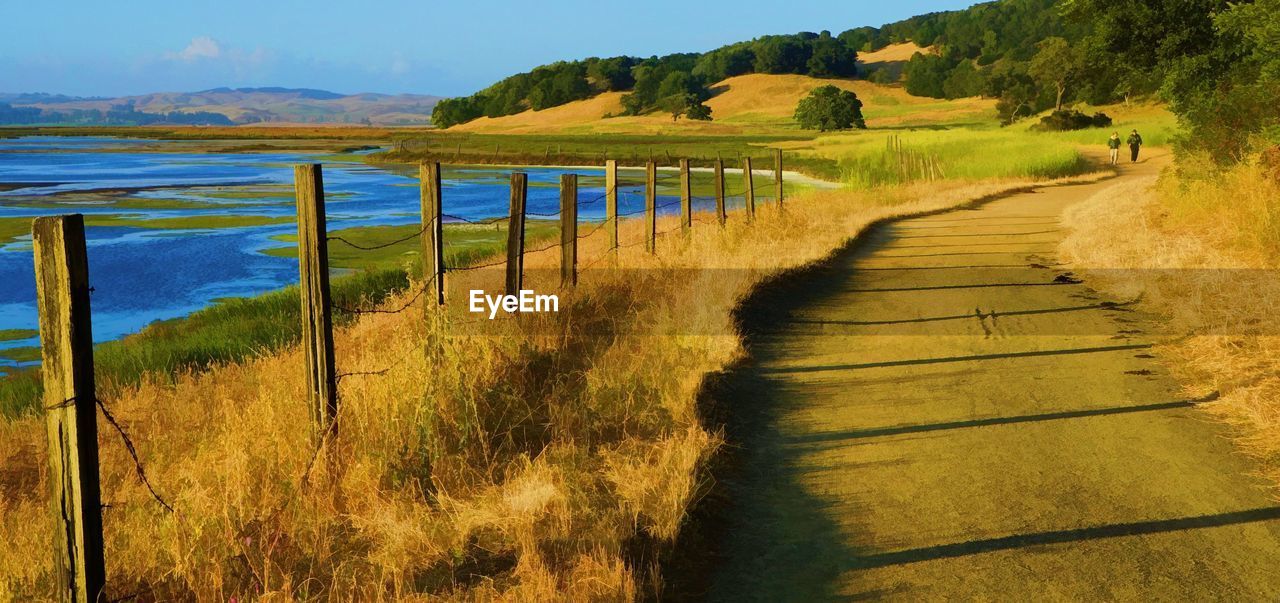 Scenic view of river amidst field against sky