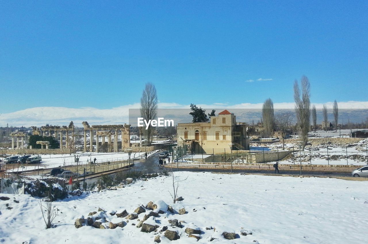 Snow covered town against sky