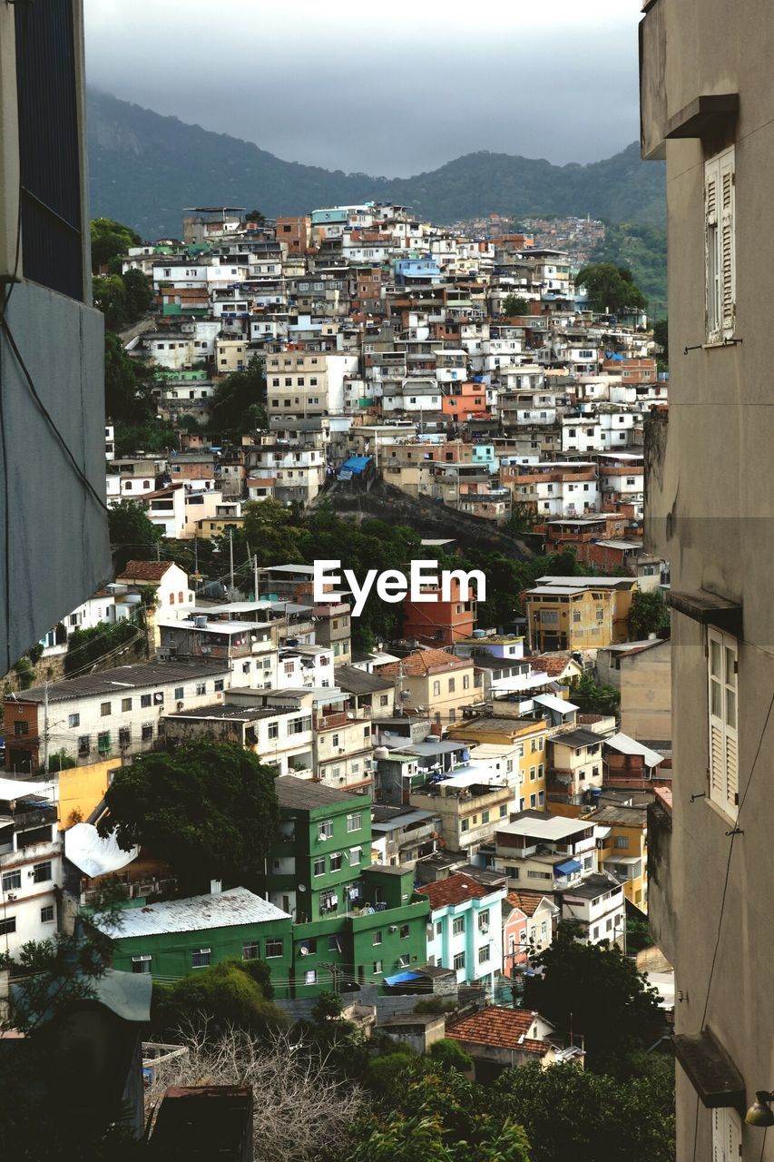 High angle view of residential buildings against mountain