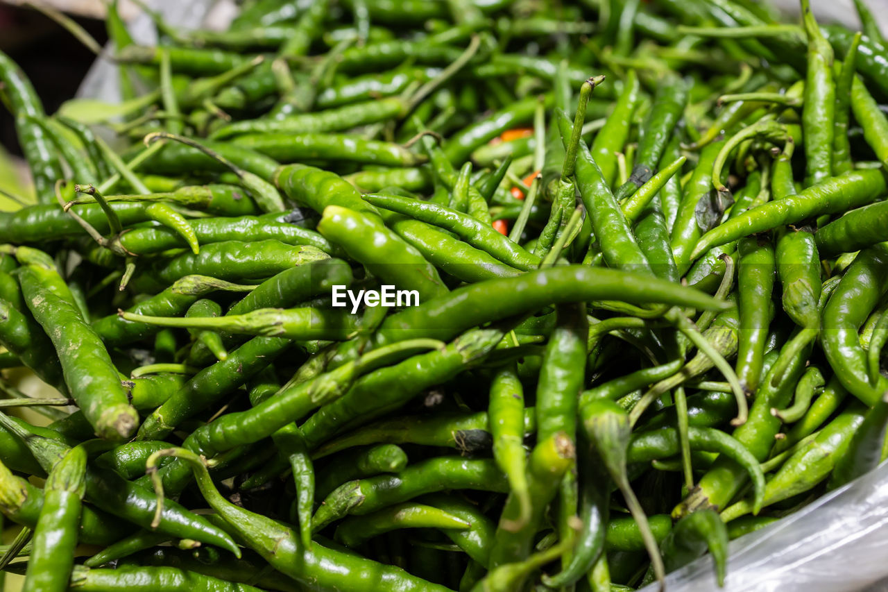 food and drink, food, vegetable, green, freshness, healthy eating, wellbeing, produce, market, large group of objects, plant, no people, retail, abundance, close-up, for sale, organic, market stall, spice, business, heap, still life, green chili pepper, raw food, pepper