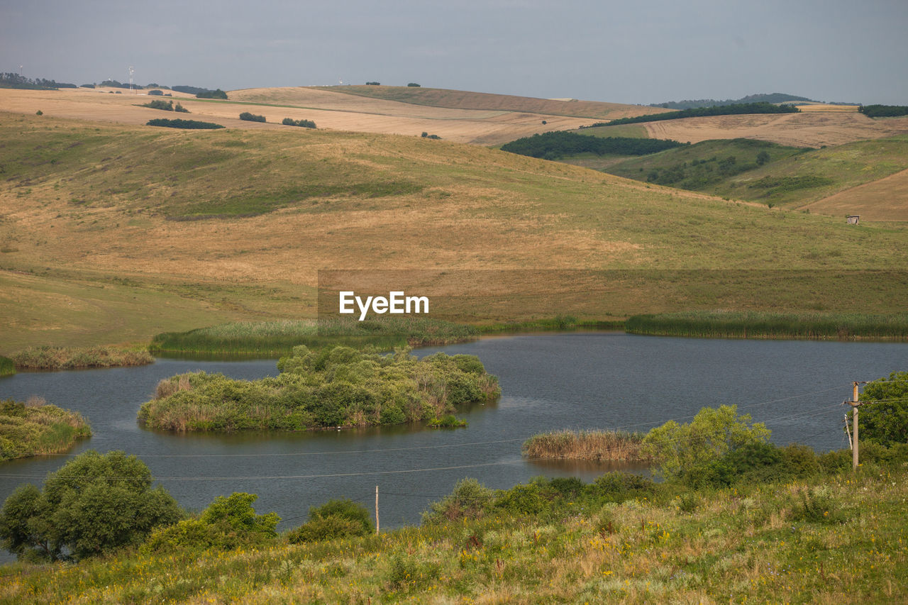 SCENIC VIEW OF LAKE AGAINST LANDSCAPE