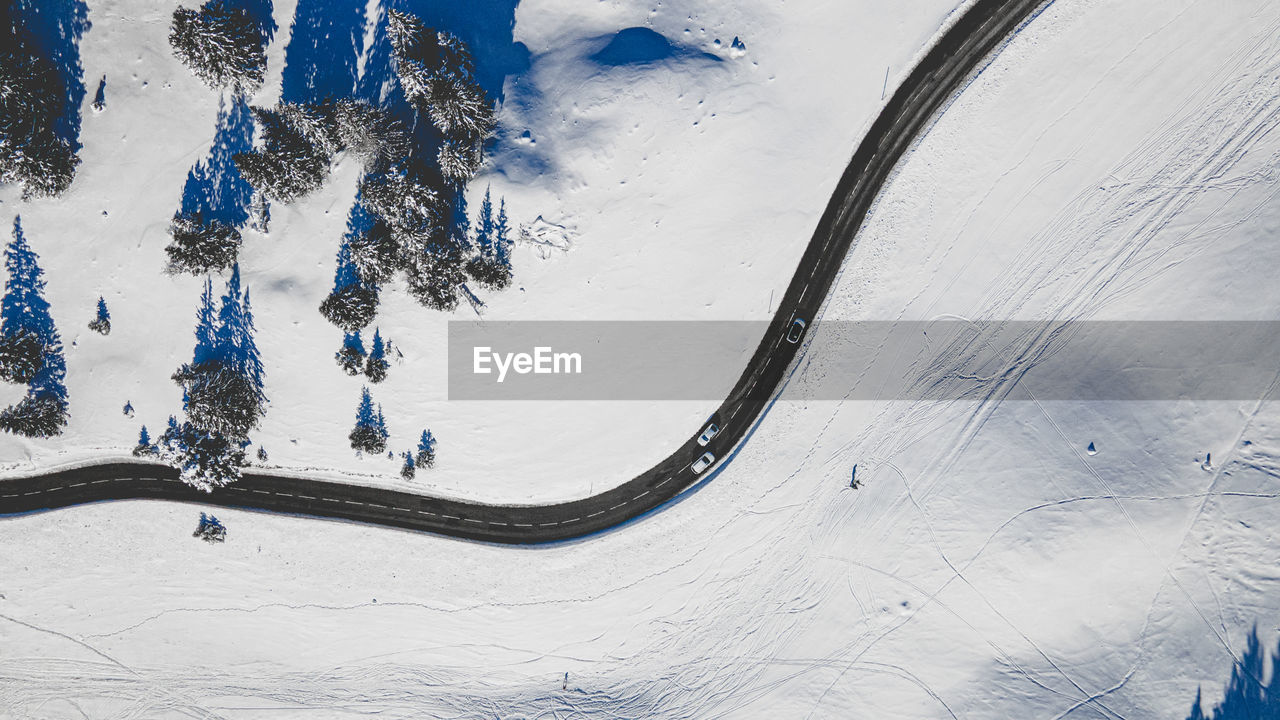 High angle view of people on snow covered mountain