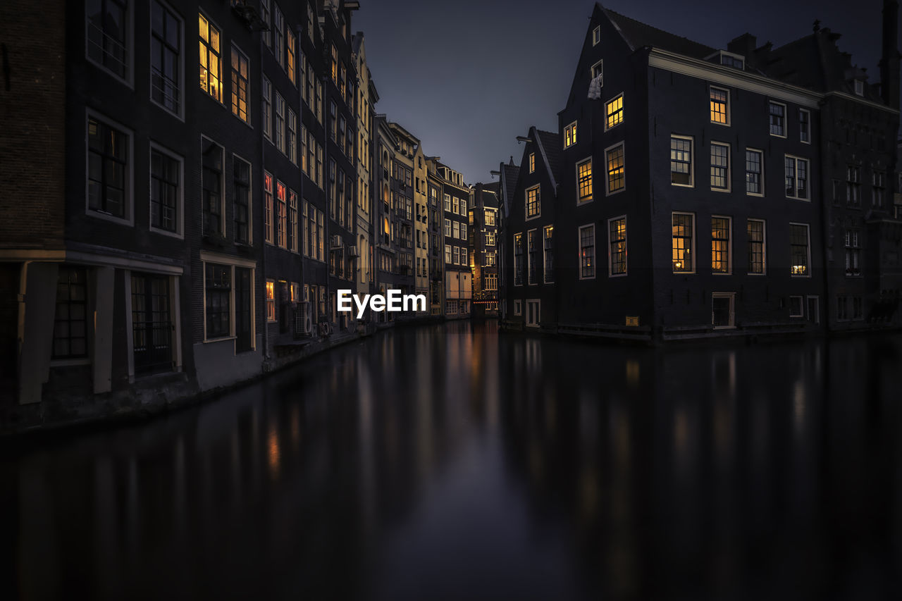 Reflection of buildings in water at night