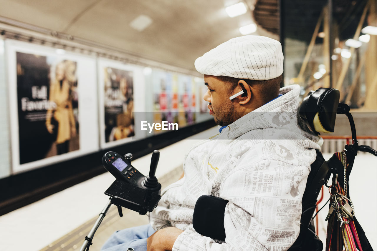 Side view of disabled man at railroad station