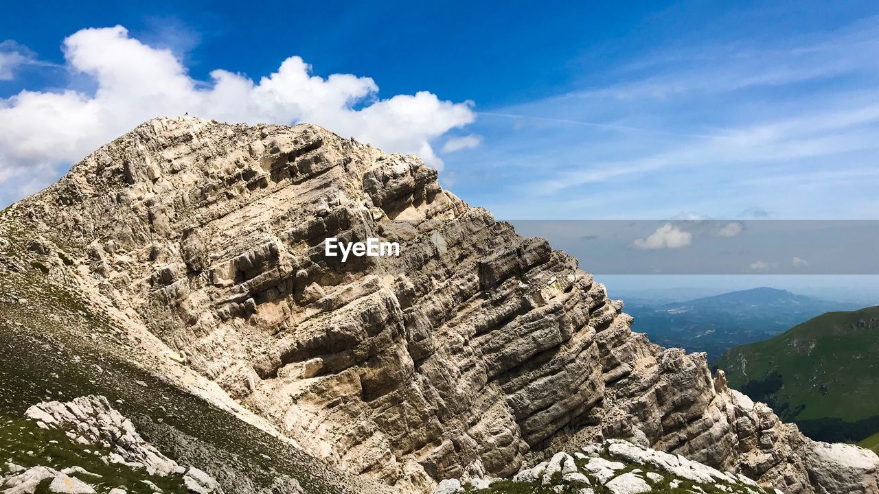 Low angle view of rock formation against sky