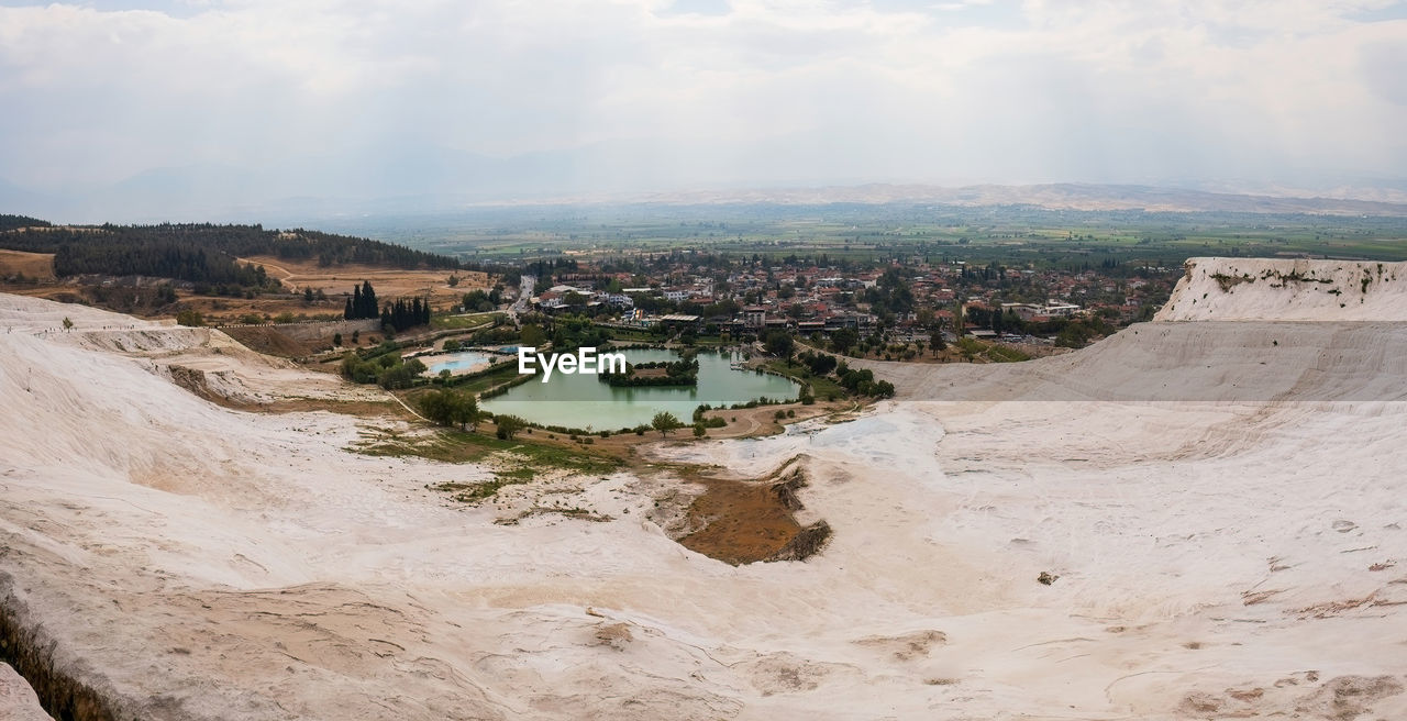 sky, nature, environment, architecture, cloud, landscape, land, sea, built structure, scenics - nature, water, building exterior, travel destinations, travel, day, outdoors, no people, coast, terrain, city, aerial photography, building, geology, high angle view, tourism, sand, beauty in nature, rock, cliff
