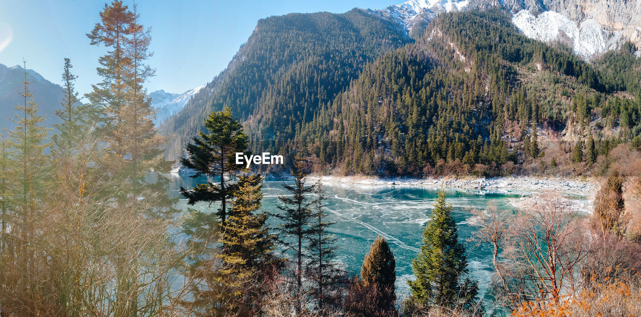 SCENIC VIEW OF WATERFALL AGAINST SKY