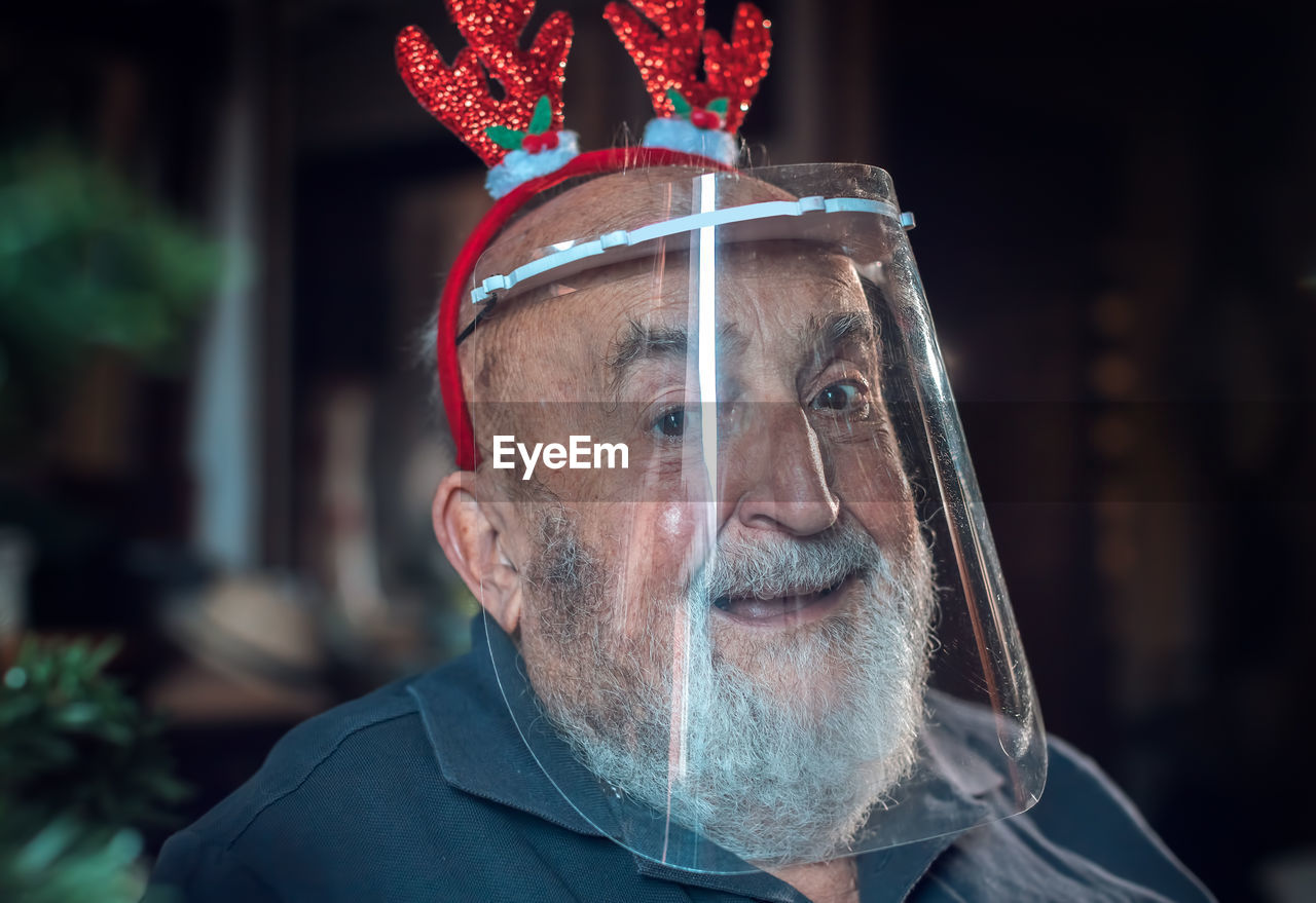 Portrait of senior man wearing face shield