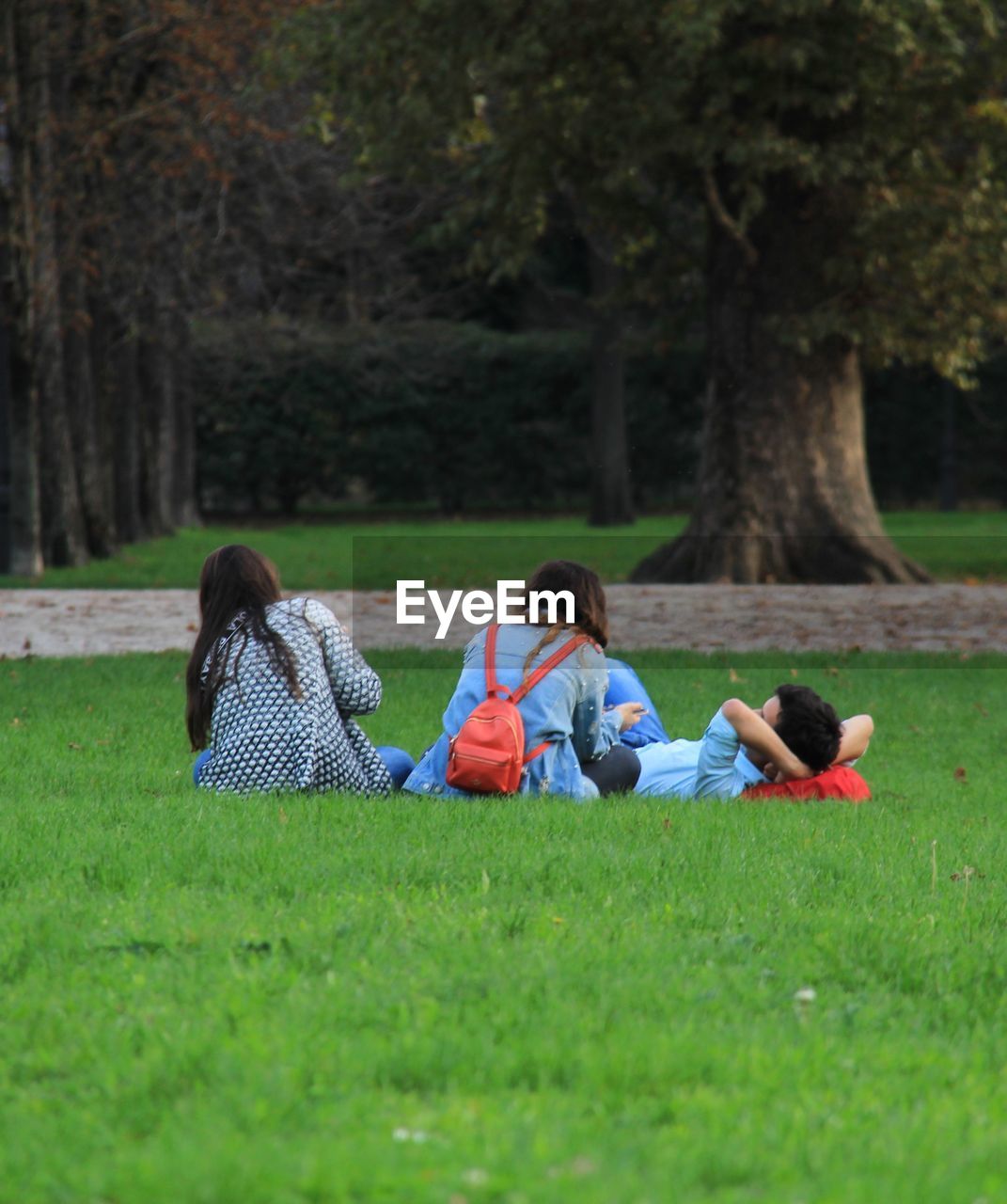 FRIENDS SITTING ON GRASS