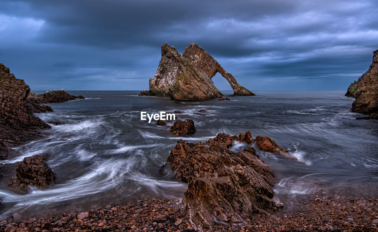 Bow fiddle rock is a natural sea arch near portknockie on the moray coast of scotland