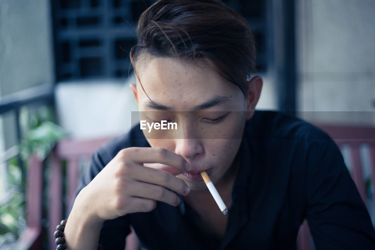 Young man smoking cigarette