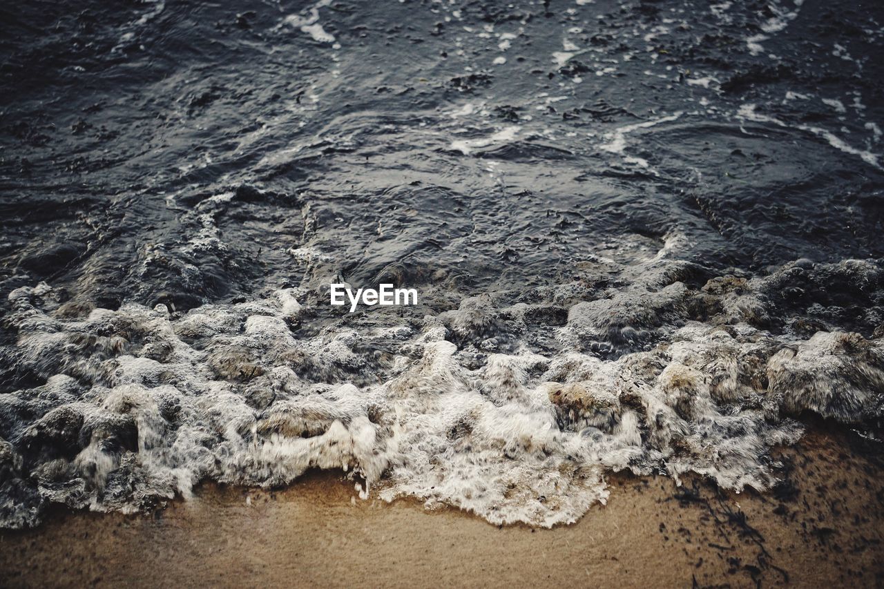 High angle view of waves reaching shore at beach