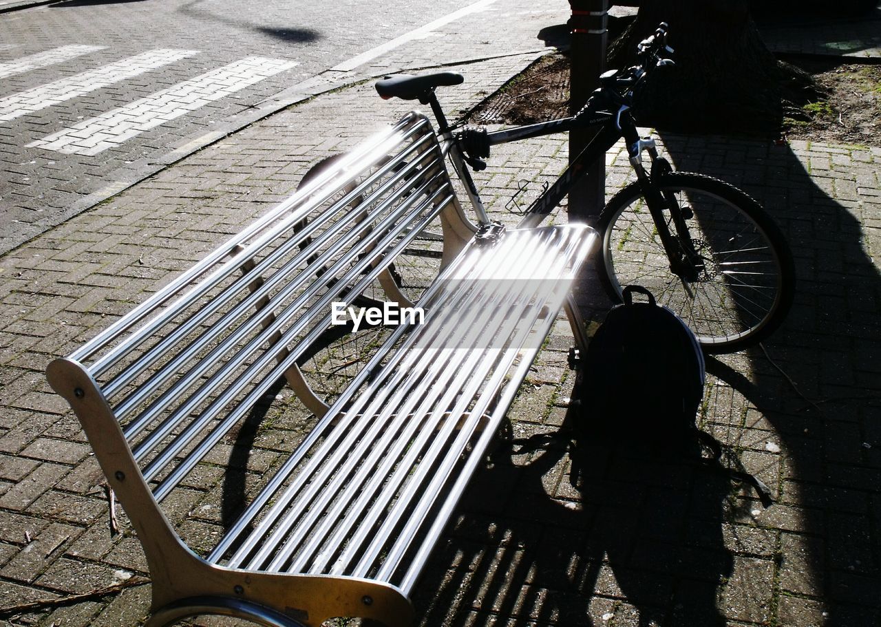 HIGH ANGLE VIEW OF MAN BICYCLE ON SHADOW