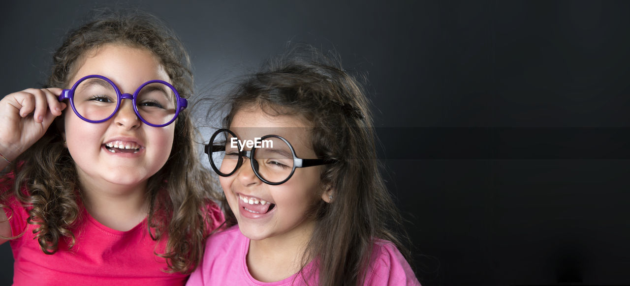 Smiling girls against black background