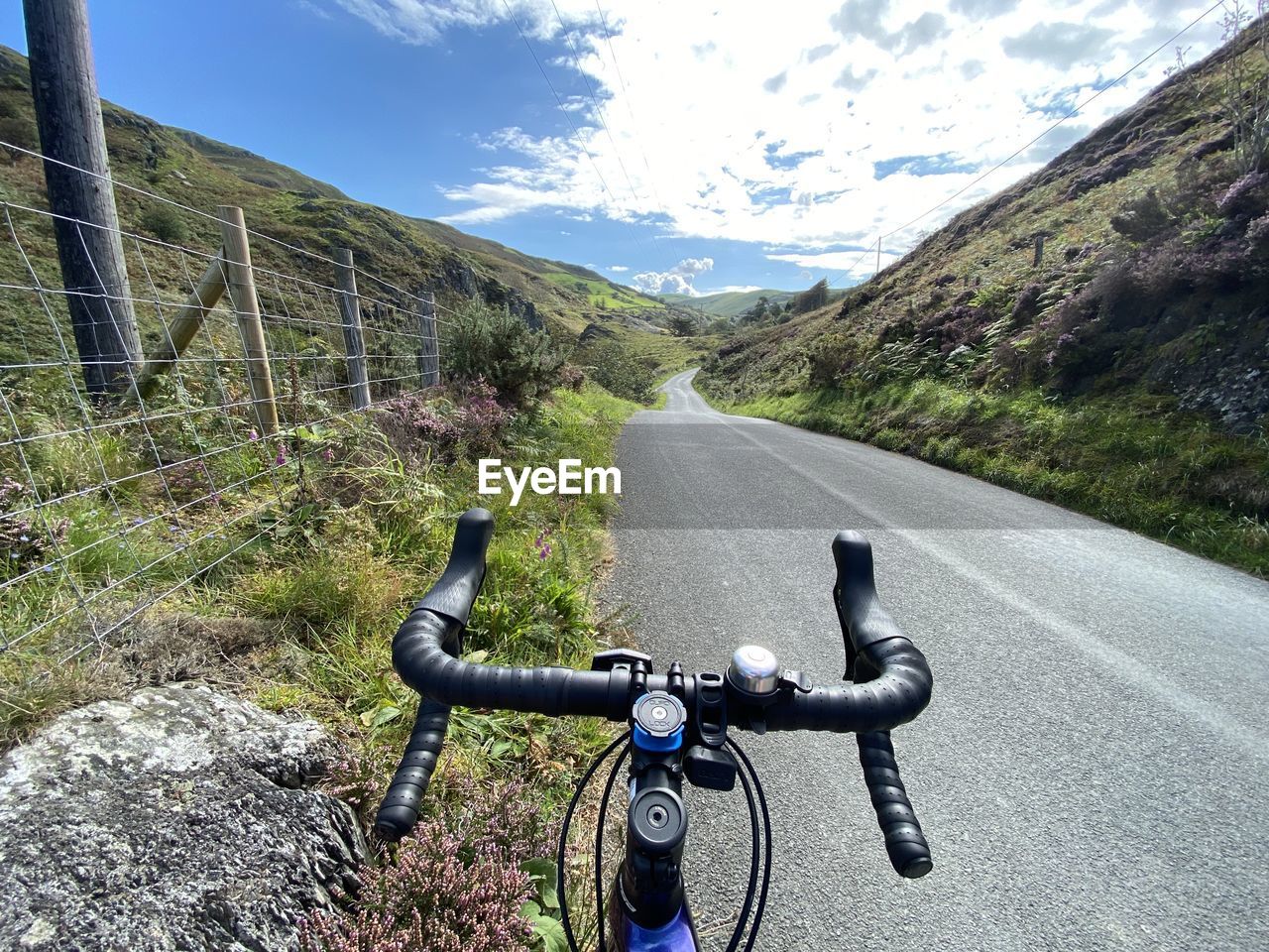 Bicycle on road by mountain against sky. majestic ride in wales. road cycling. hills. climbing. 