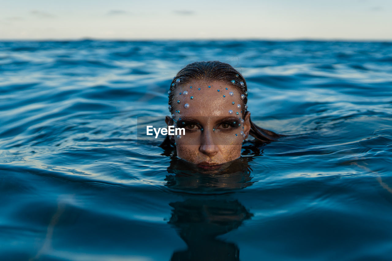 Portrait of woman swimming in water